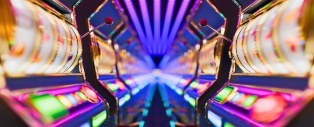Brightly colored slot machines in a symmetrical layout with vivid neon lights, showcasing a lively and dynamic casino atmosphere bringing a thrilling gaming experience to life