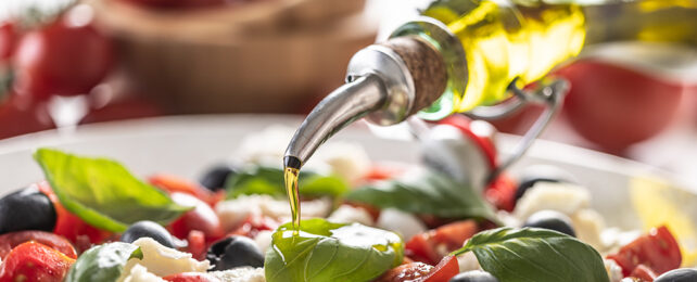 Pouring olive oil over food