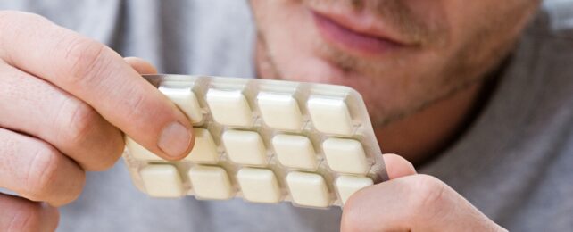 Man holding nicotine gum