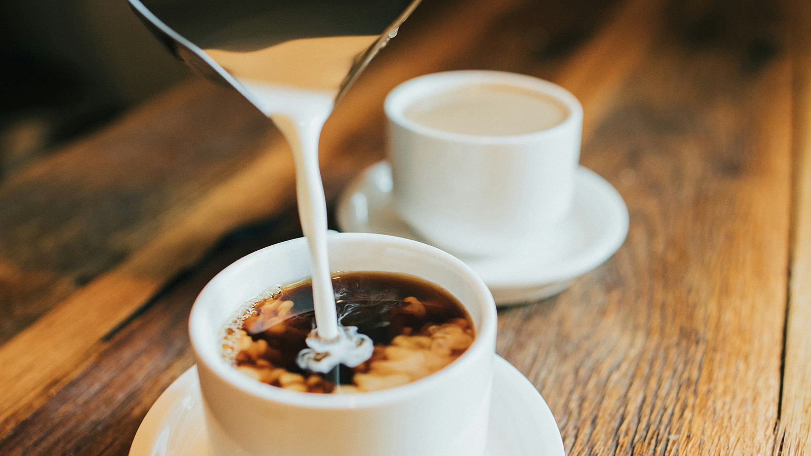 Pouring milk into coffee