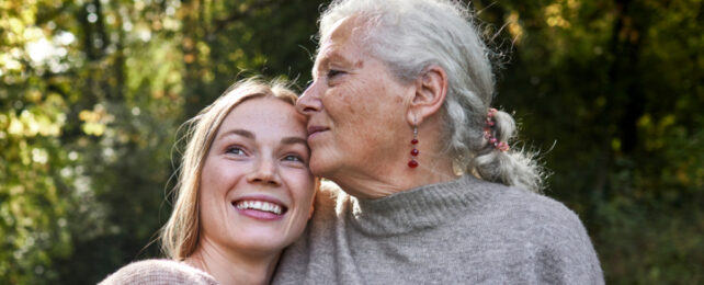older woman embracing younger woman