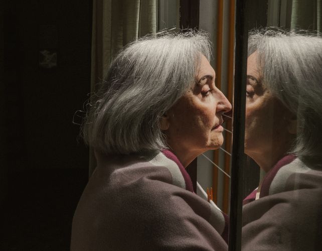 older woman at a window