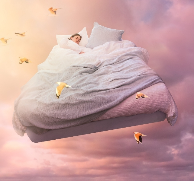 person on a bed in the sky