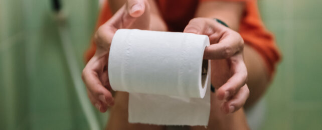 hands holding toilet paper