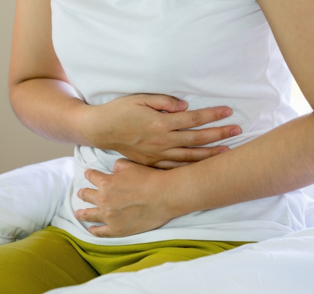 woman clenching stomach