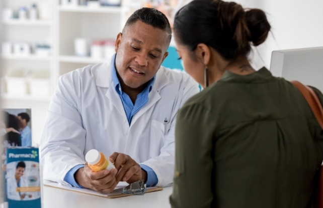 pharmacist advising customer