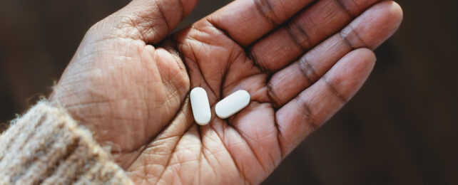 white pills in palm of a hand