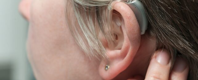 Young adult wearing hearing aid