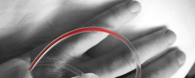 blood in a tube on back of hand
