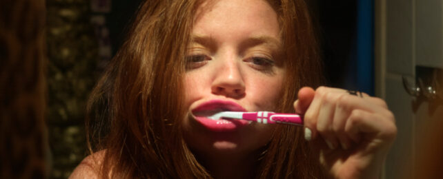 woman brushing teeth before bed