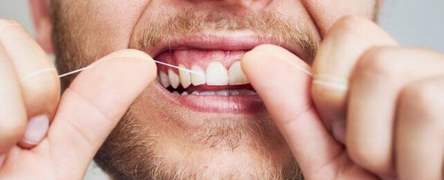 man flossing