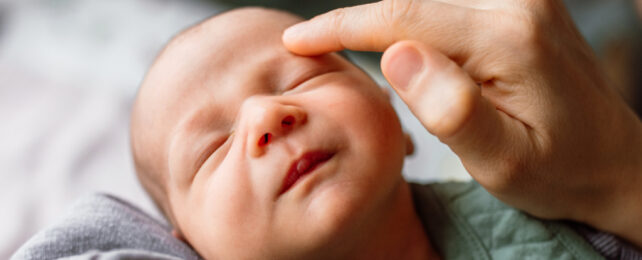 newborn being stroked