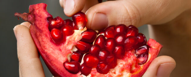 pomegranate with fingers