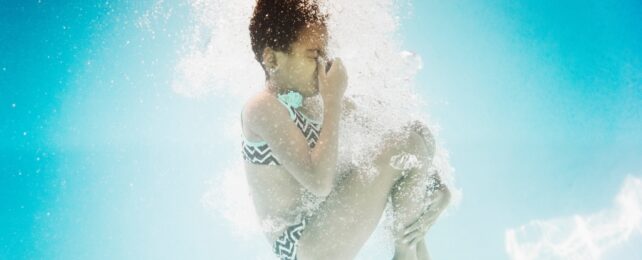 girl underwater in a pool