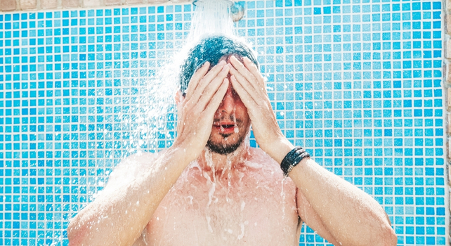 man showering at a pool