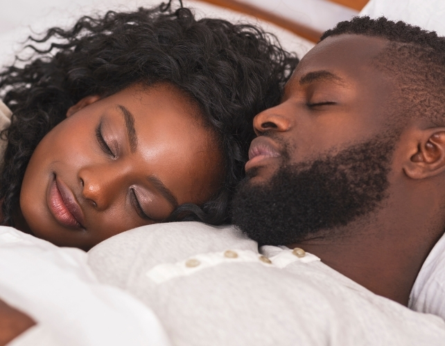 couple sleeping in the same bed