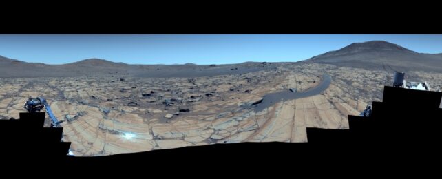 Panorama of Mars in blue Earth-like colors, showing cameras in foreground