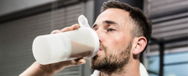 Muscular man drinking protein shake