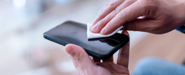 man wiping phone