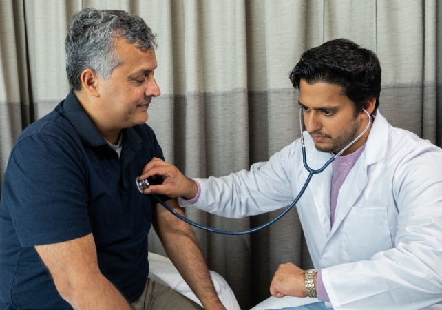 doctor listening to man's heart