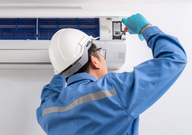technician maintaining ac