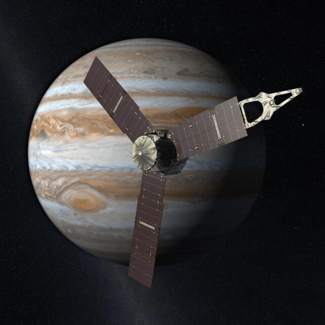 An image of a brown planet with a spacecraft in the foreground 