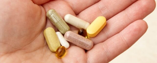 supplements in person's hand