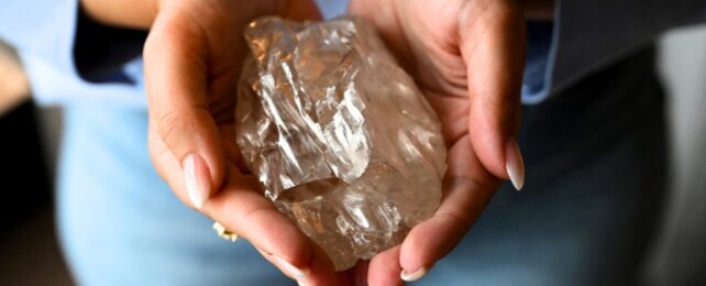 diamond held in two hands