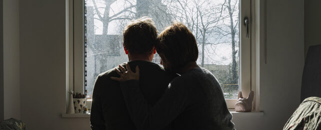 Couple in front of a window