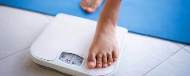 A foot stepping onto a scale