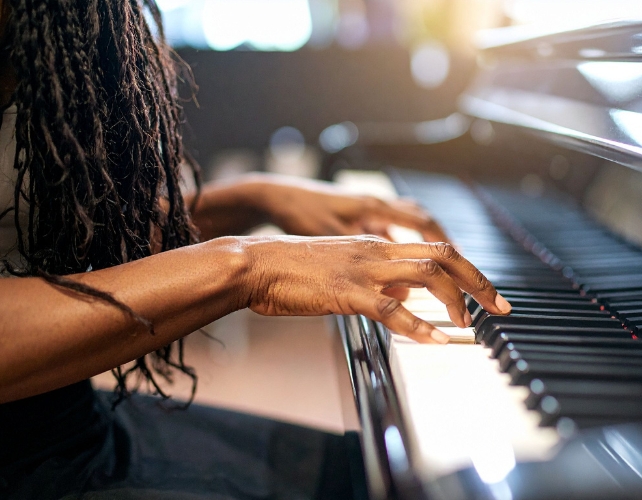 Hands playing a piano