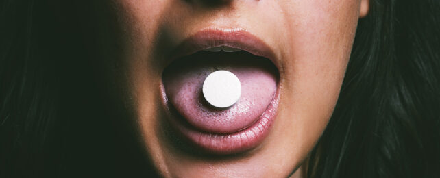 Woman taking a pill