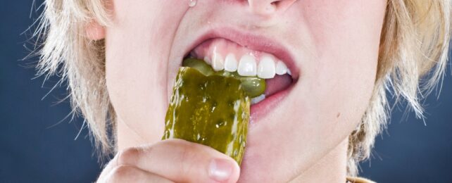 man eating pickle