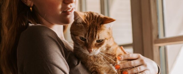 woman holding her cat