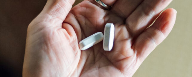 white pills in the palm of the hand