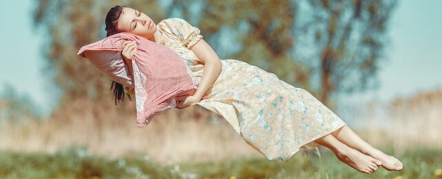 woman floating with pillow