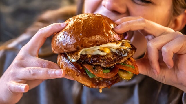 Someone eating a burger