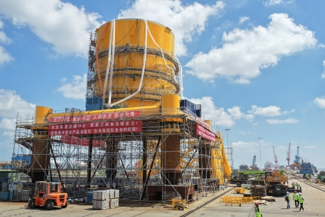 A large yellow data center under construction 