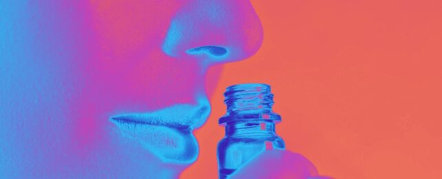Close up of nose smelling a vial, in bright colors