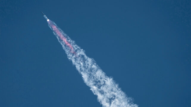 A rocket soaring in blue sky