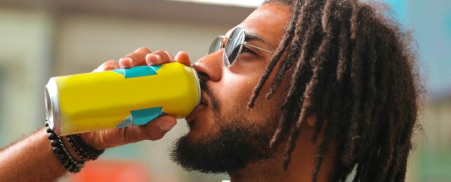 man drinking from a can