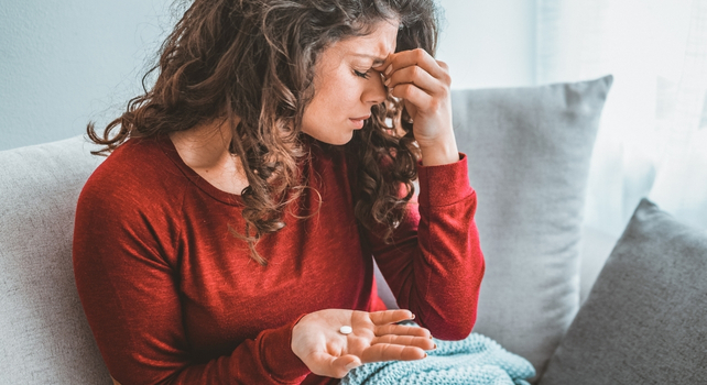 woman pinching eyes in pain