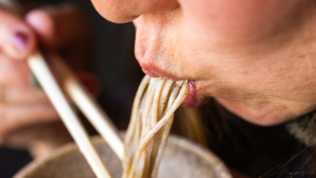 woman slurping noodles