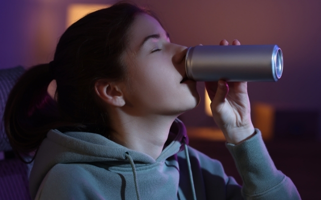 girl drinking from a can
