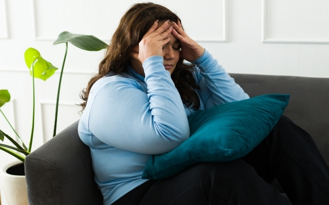 woman on the couch looking depressed