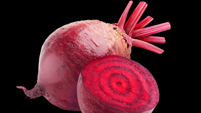 One whole beetroot behind one half beetroot