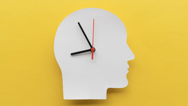 Paper clock in the shape of a head