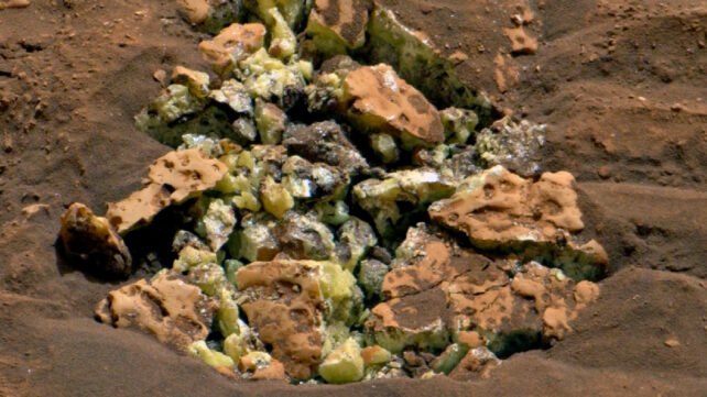 Yellow crystals that were revealed after NASA’s Curiosity happened to drive over a rock and crack it open