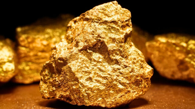 Closeup of big gold nugget, with multiple nuggets in background
