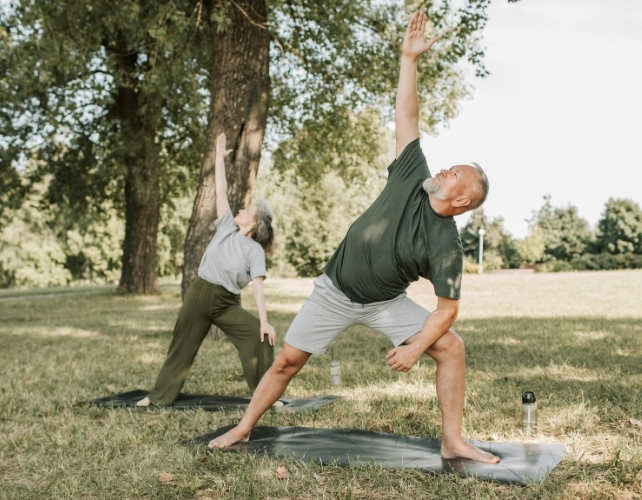 A Man and Woman Doing Exercise Outdoors